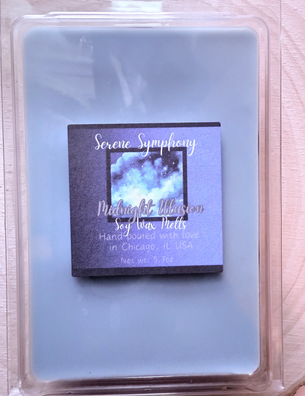 Soy wax melt package labeled 'Serene Symphony Midnight Affection' in a clear container.